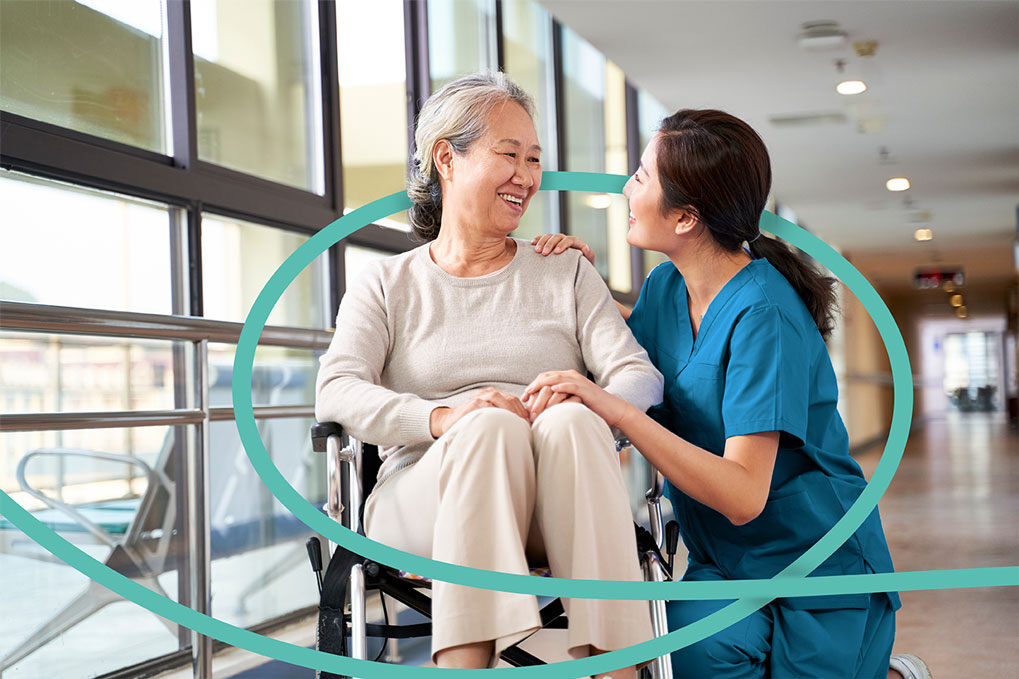 Hospital patient in wheelchair in being cared for by HCP. Hospital patient in wheelchair in being cared for by HCP.
